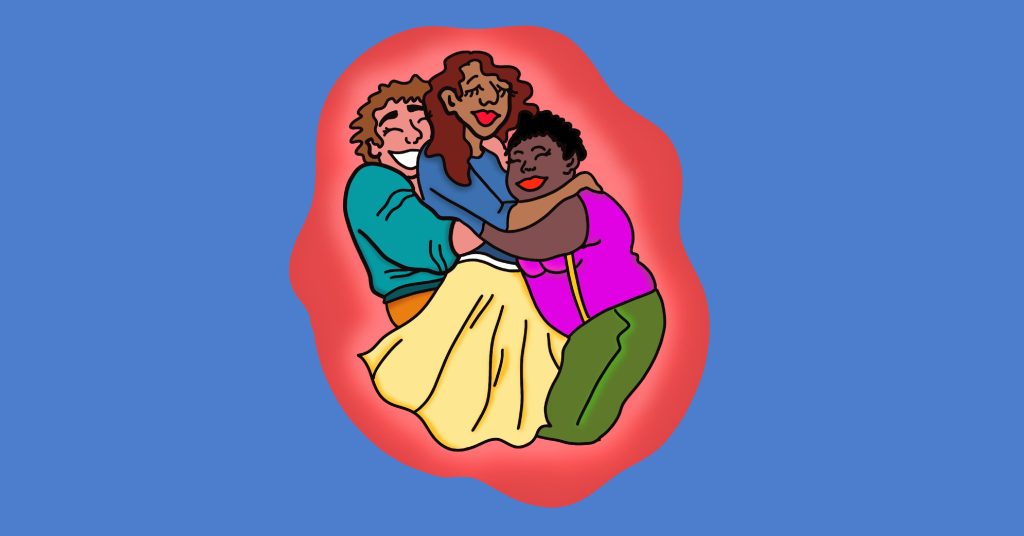 Three gender-diverse people dressed in colourful clothing share a warm and joyful hug.