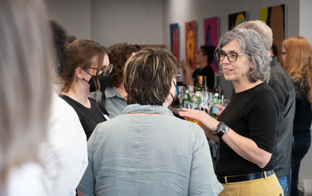 Photo of Dr. Martha Dow talking to guests in the CHASI Hub