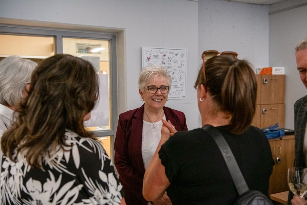 Photo of Dr. Joanne Maclean speaking to several other guests.