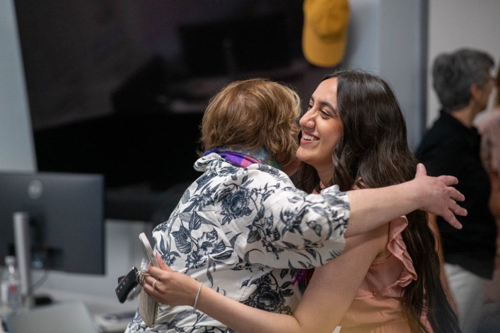 Two members of the CHASI team share a hug.