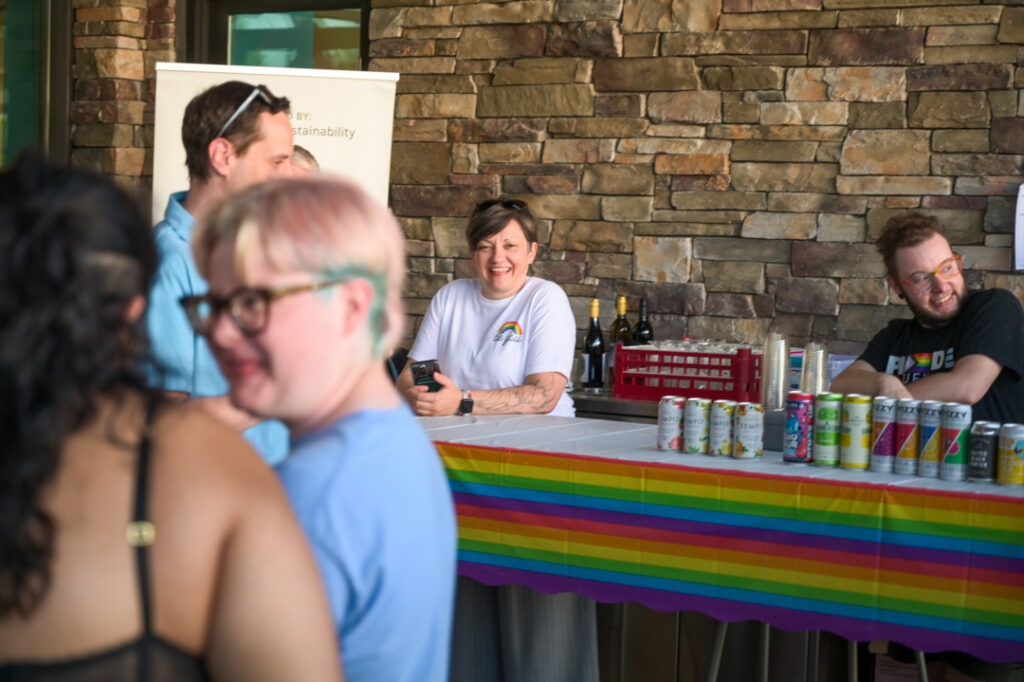 Photo of the bar at the Tea Dance, being bar-tended by Amy Mykes and Alec Zinman.