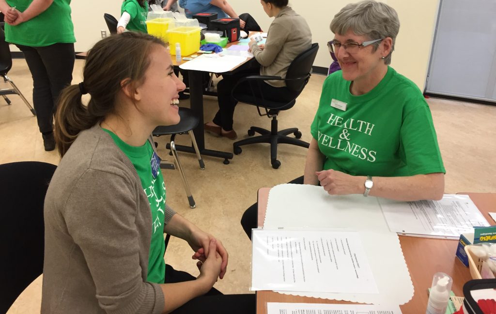 Getting prepped for the free flu and pneumonia vaccinations. Fourth year nursing student Stefanie Strukoff practices the interview process with Nursing prof Sheila Edwards 