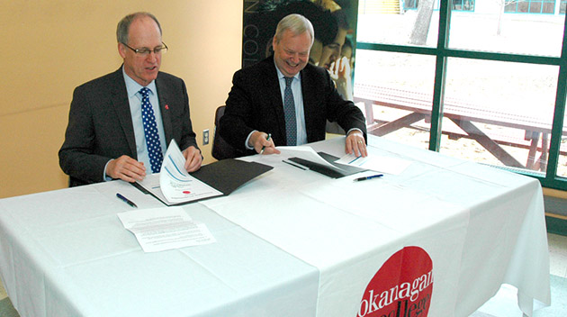Okanagan College President Jim Hamilton and UFV President and Vice-Chancellor Dr. Mark Evered sign agreement in Salmon Arm.