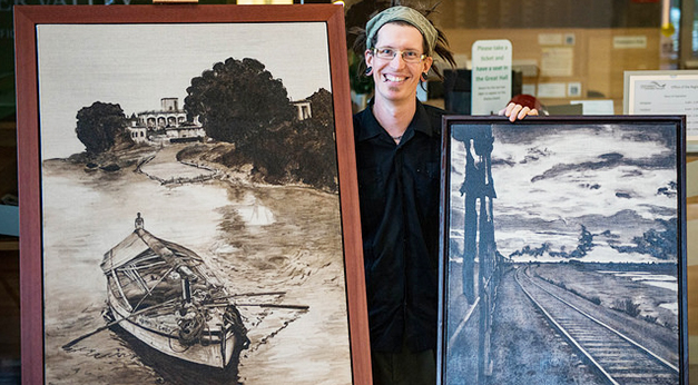 Fine Arts alumnus Colin Mitchell with the paintings that adorn this year's alumni wine labels.