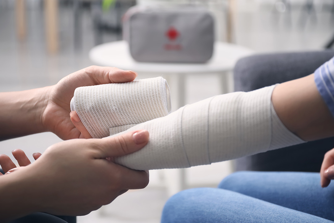 Stock photo of a bandage being applied to a person's arm