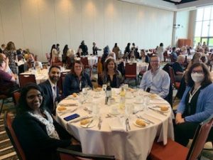 Awneet, Claire and the attending 3M members sitting at a round table for dinner at the STHLE 2023 Conference