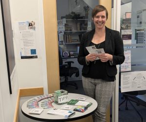 Anna Griffith standing next to the Changemaker TIPP Fund display