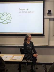 Theresa Southam sitting in front of a projector screen