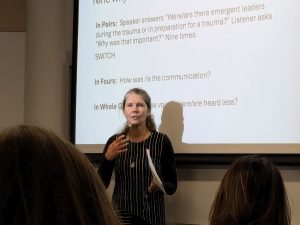 Theresa Southam standing in front of a projector screen