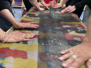 hands on a table with material