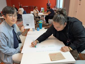 Soowook and Leanne writing on a giant poster