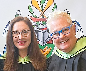 Andrea and Smitting wearing convocation gowns