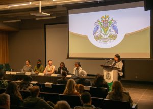 Holly Janzen, Moninder Grewal, Rebekah Stokes, Simosethu Mpofu, Amanjot Dhaliwal. Dr. Geetanjali Gill at podium.